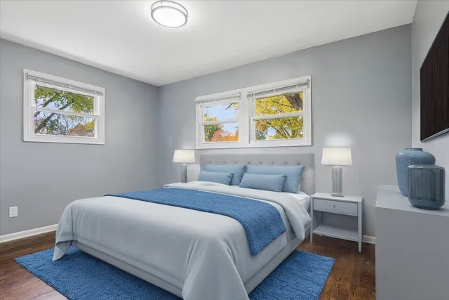 a bedroom with a bed and a painting on the wall