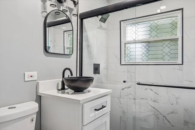 a bathroom with a toilet sink and mirror