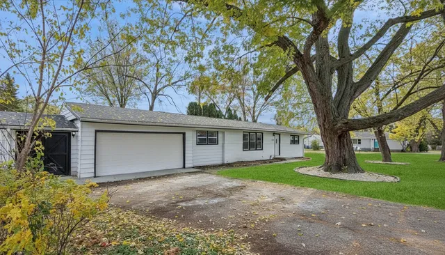 a house that has a tree in front of the house