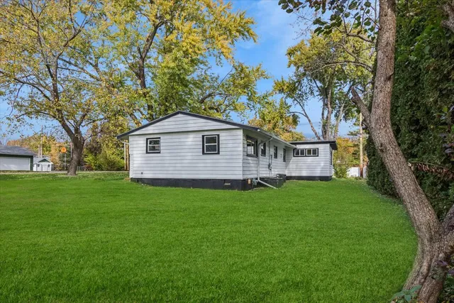 a backyard of a house with table and chairs