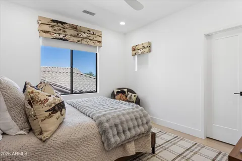 a bedroom with bed and a window