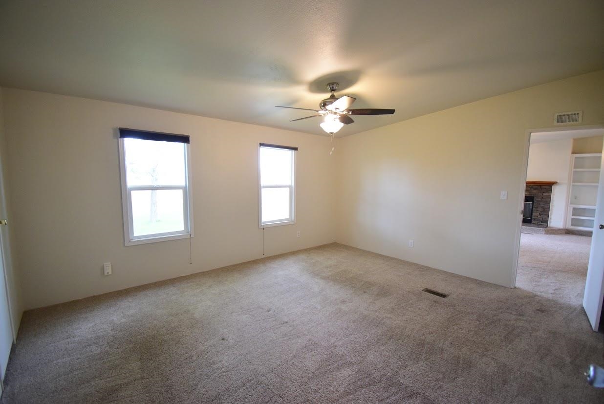 19548 B50 Road Delta, CO 81416 - Photo 14 of 37 an empty room with windows and ceiling fan