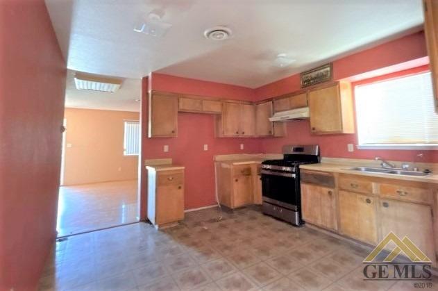 Undisclosed Address Delano, CA 93215 - Photo 3 of 14 a kitchen with a sink cabinets stainless steel appliances and a window