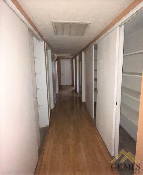 Undisclosed Address Delano, CA 93215 - Photo 4 of 14 a view of a hallway with wooden floor