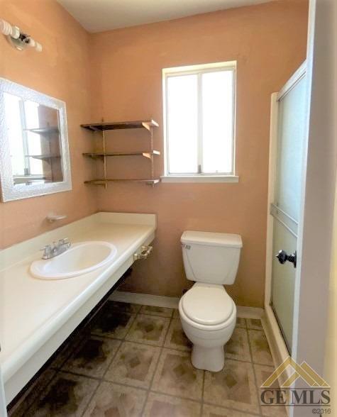 Undisclosed Address Delano, CA 93215 - Photo 6 of 14 a bathroom with a toilet sink and a mirror