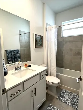 a bathroom with a sink toilet tub and shower