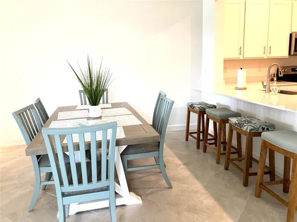 a view of a dining room with furniture and a potted plant