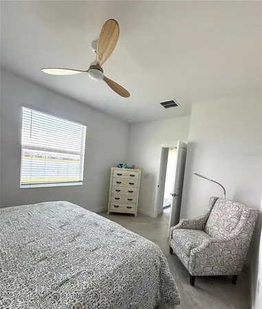 a bedroom with a bed and a couch