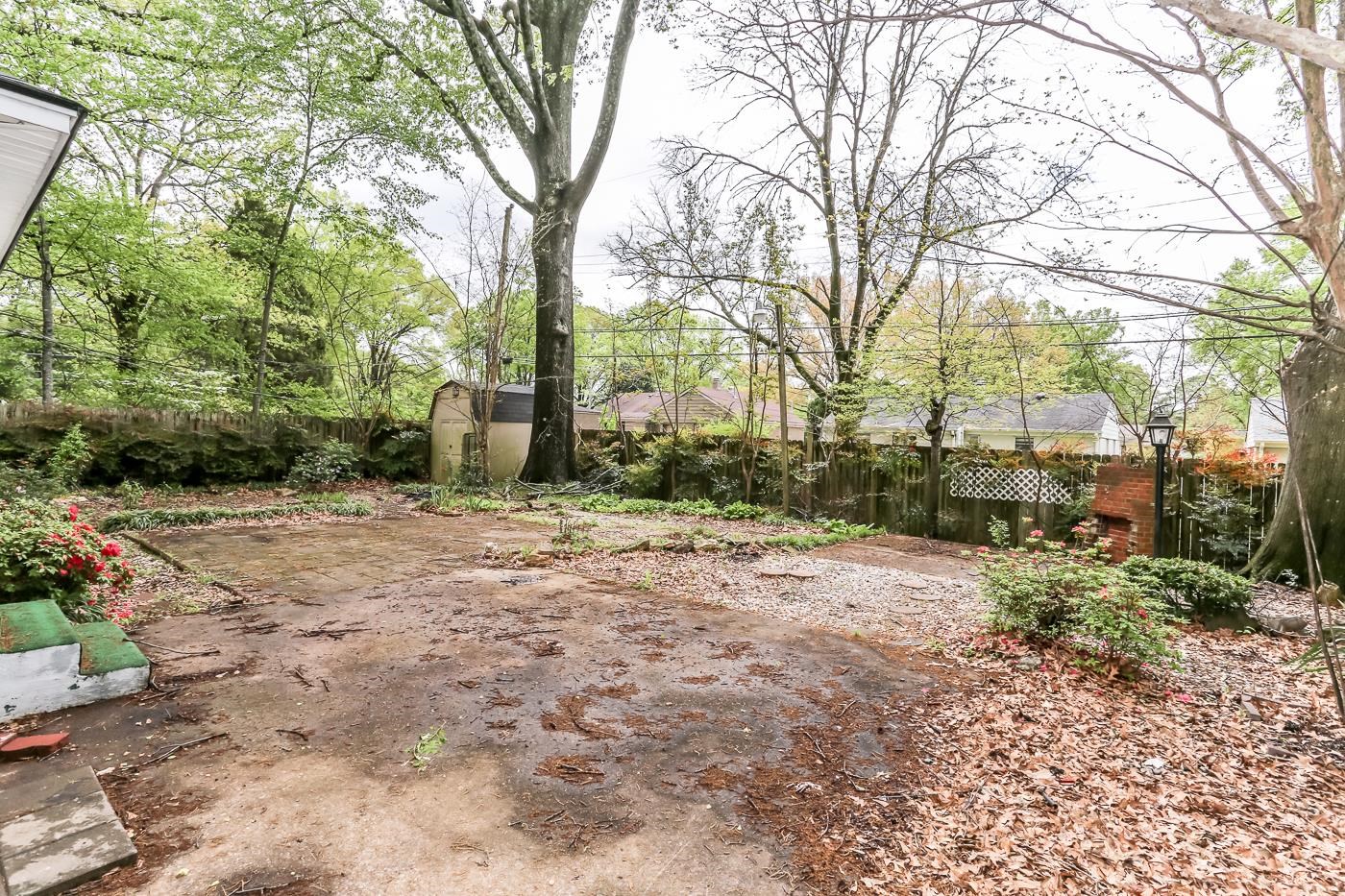 4969 Amboy Road Memphis, TN 38117 - Photo 18 of 19 a backyard of a house with lots of green space