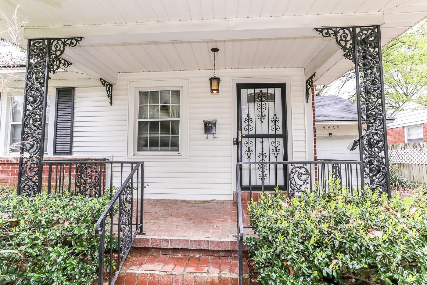 4969 Amboy Road Memphis, TN 38117 - Photo 2 of 19 a front view of a house with a garden