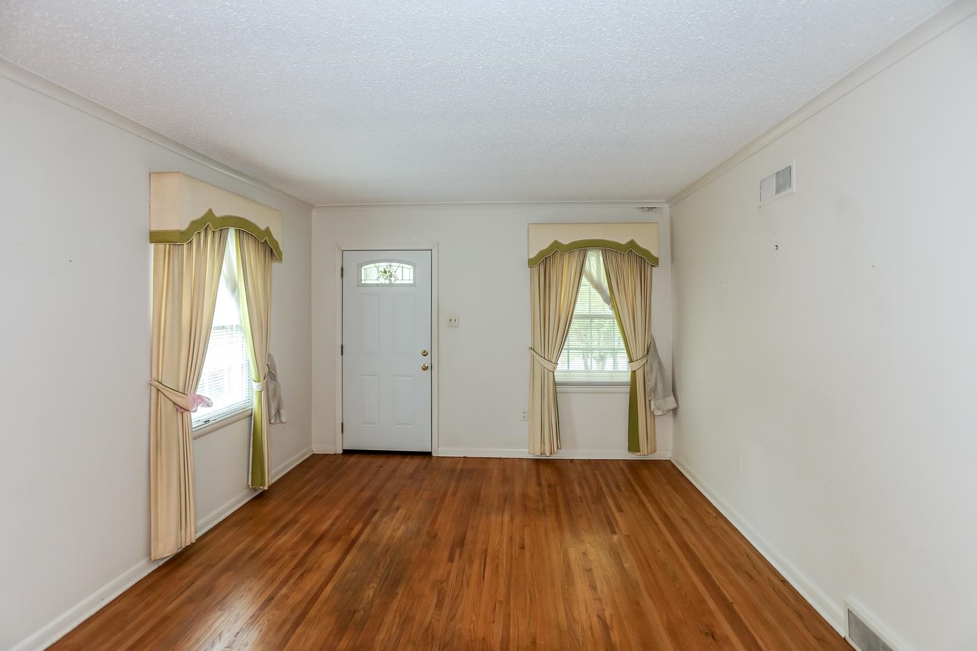 4969 Amboy Road Memphis, TN 38117 - Photo 3 of 19 an empty room with wooden floor and windows