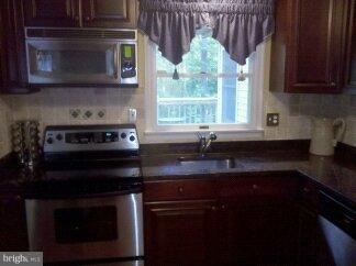 2676 Walston Road Mount Airy, MD 21771 - Photo 15 of 28 a kitchen with stainless steel appliances granite countertop a stove a sink and a microwave