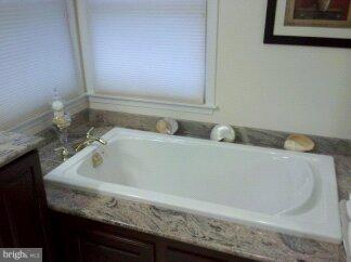 2676 Walston Road Mount Airy, MD 21771 - Photo 3 of 28 a bathroom with a granite countertop tub and sink