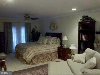 2676 Walston Road Mount Airy, MD 21771 - Photo 23 of 28 a bedroom with a bed and wooden floor