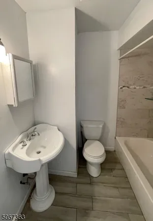 a bathroom with a sink a toilet and bathtub