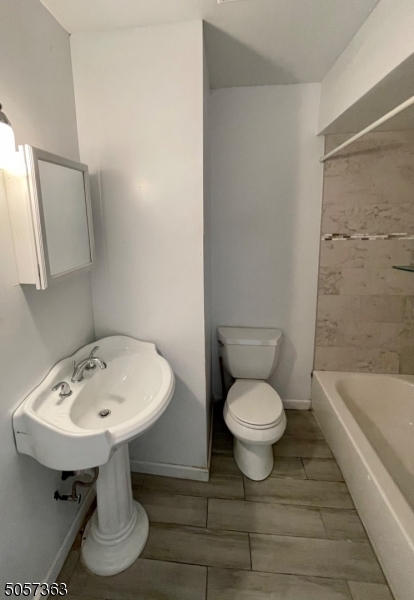 177 Beech Street Paterson, NJ 07501 - Photo 2 of 10 a bathroom with a sink a toilet and bathtub