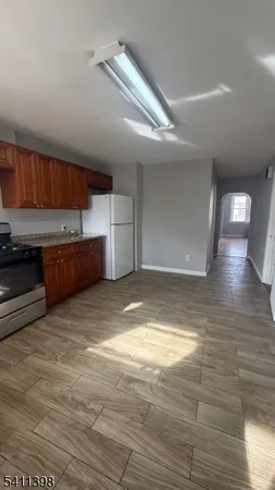 a view of kitchen and empty room