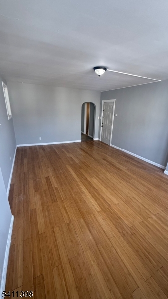 177 Beech Street Paterson, NJ 07501 - Photo 4 of 10 a view of empty room with wooden floor