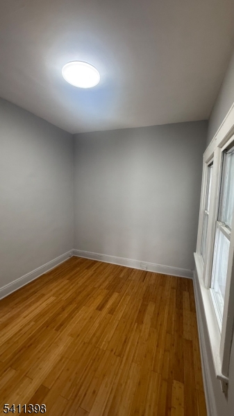 177 Beech Street Paterson, NJ 07501 - Photo 5 of 10 a view of empty room with wooden floor and fan