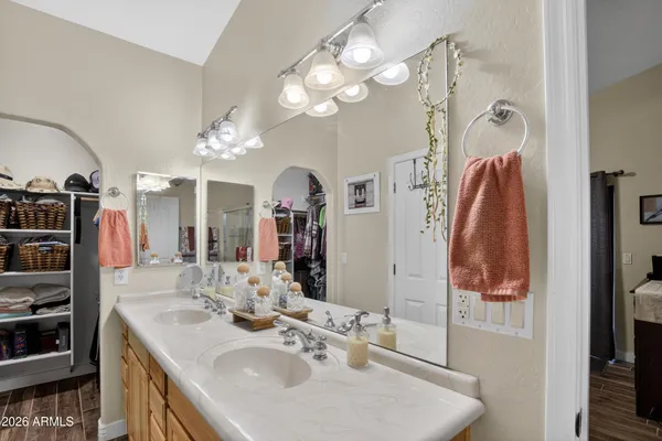 a en suite bathroom with a sink vanity and mirror
