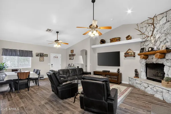 a living room with furniture a fireplace and a flat screen tv