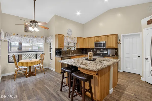 a kitchen with a table chairs refrigerator and cabinets