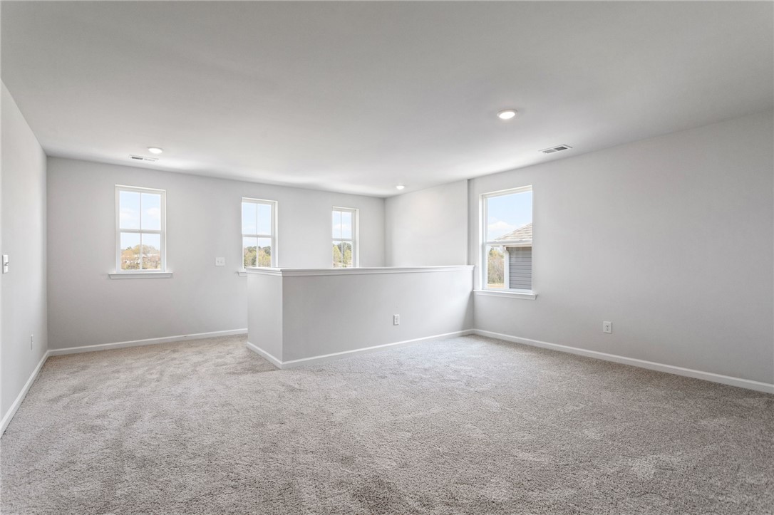 146 Cedar Shoals Easley, SC 29640 - Photo 20 of 34 This spacious loft area offers abundant natural light, perfect for a flexible living space.