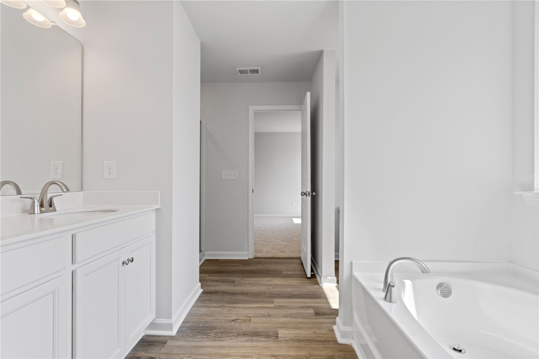 146 Cedar Shoals Easley, SC 29640 - Photo 24 of 34 This primary bathroom features a double vanity and a soaking tub, offering a serene retreat.