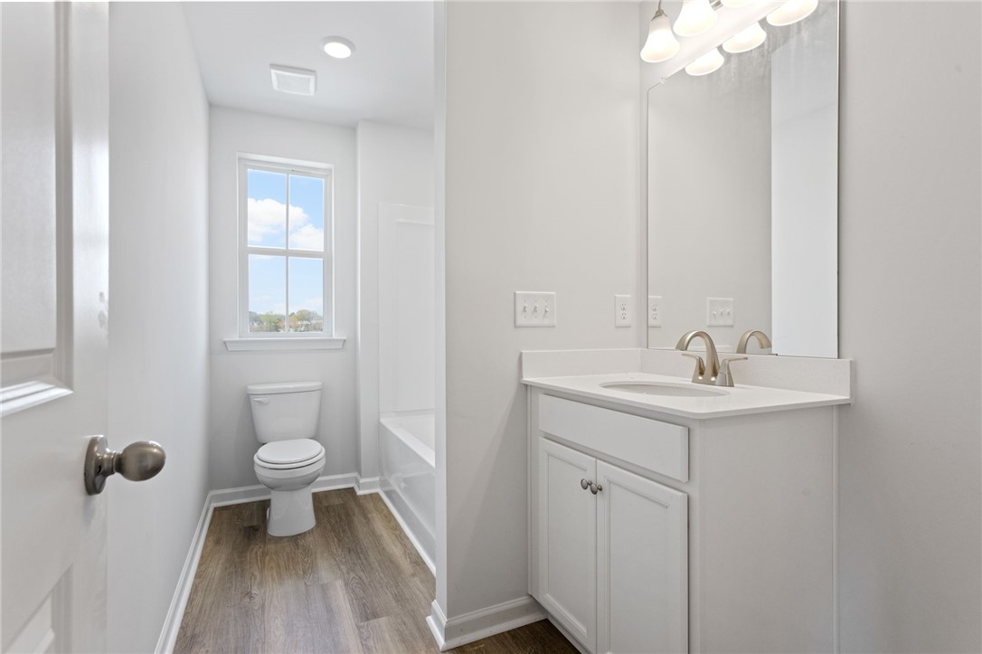 146 Cedar Shoals Easley, SC 29640 - Photo 26 of 34 This bright bathroom features ample light and contemporary fixtures.