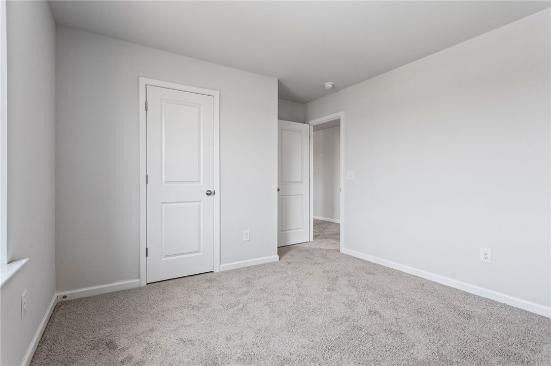 146 Cedar Shoals Easley, SC 29640 - Photo 28 of 34 This spacious bedroom offers ample natural light and a clean, neutral palette.