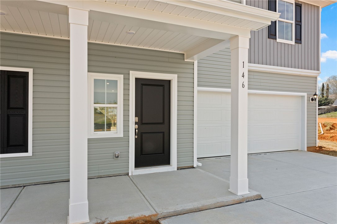 146 Cedar Shoals Easley, SC 29640 - Photo 3 of 34 This contemporary home features an inviting covered entryway and a two-car garage.