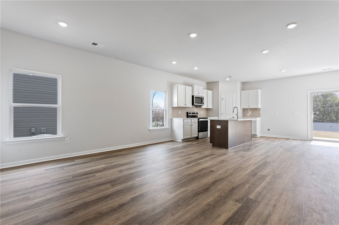 146 Cedar Shoals Easley, SC 29640 - Photo 6 of 34 This bright, open-concept interior features wood flooring and a modern kitchen.