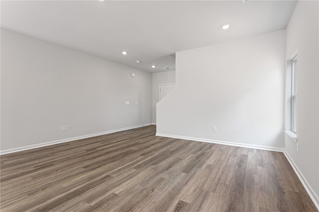 146 Cedar Shoals Easley, SC 29640 - Photo 8 of 34 This expansive space features rich flooring and abundant natural light, creating an inviting atmosphere.