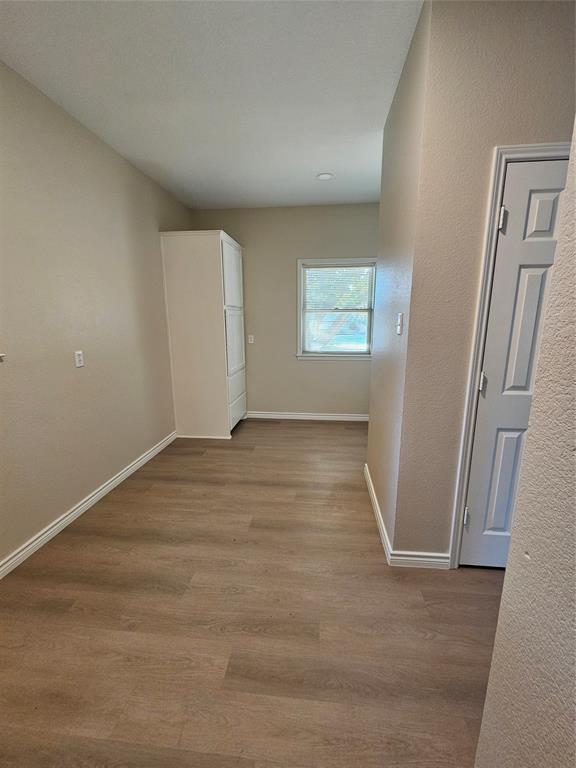 204 West Rentz Street Weatherford, TX 76086 - Photo 12 of 32 Wood-finish flooring, recessed lighting, and a white paneled door