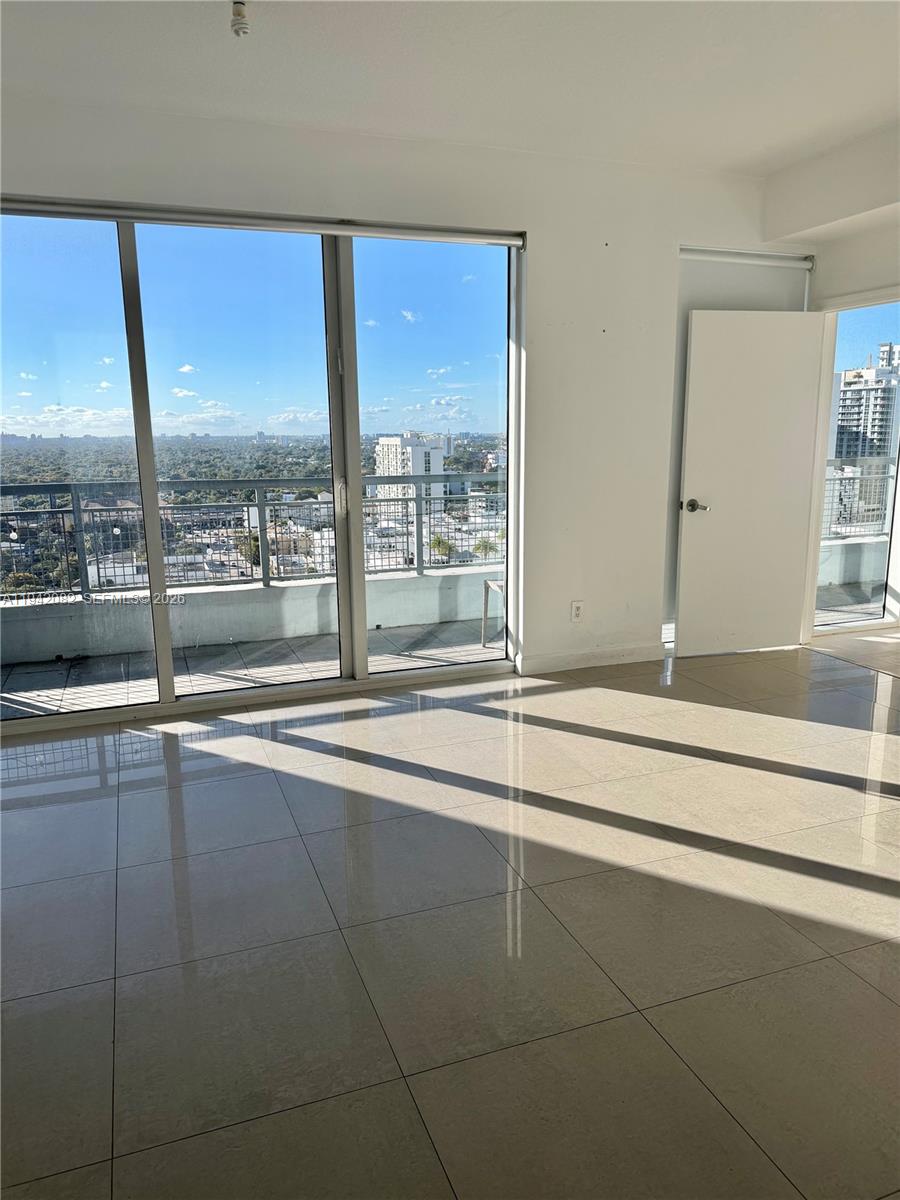 60 Southwest 13th Street, Unit 1519 Miami, FL 33130 - Photo 6 of 6 a view of a kitchen with microwave and floor to ceiling window