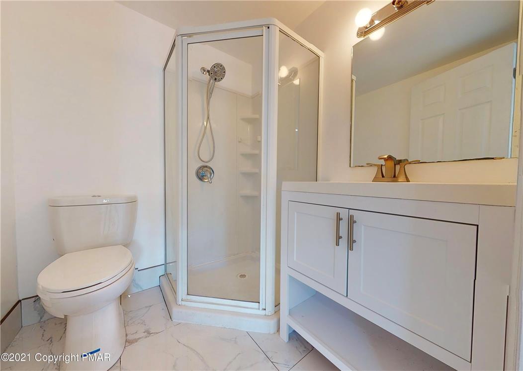 1110 Misty Ridge East Stroudsburg, PA 18302 - Photo 29 of 43 A well-appointed bathroom features a glass-enclosed shower, a sleek vanity, and modern fixtures.