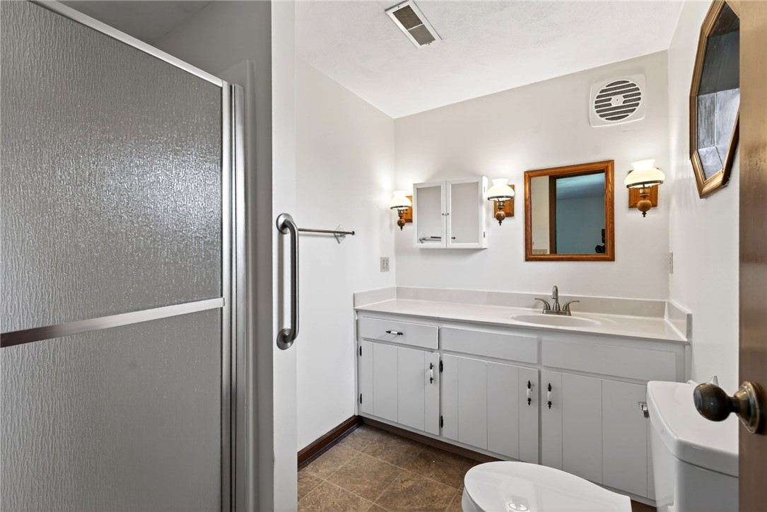 7988 McCool Road Greenville, OH 45331 - Photo 22 of 50 This bathroom features a functional vanity and a convenient shower for daily routines.