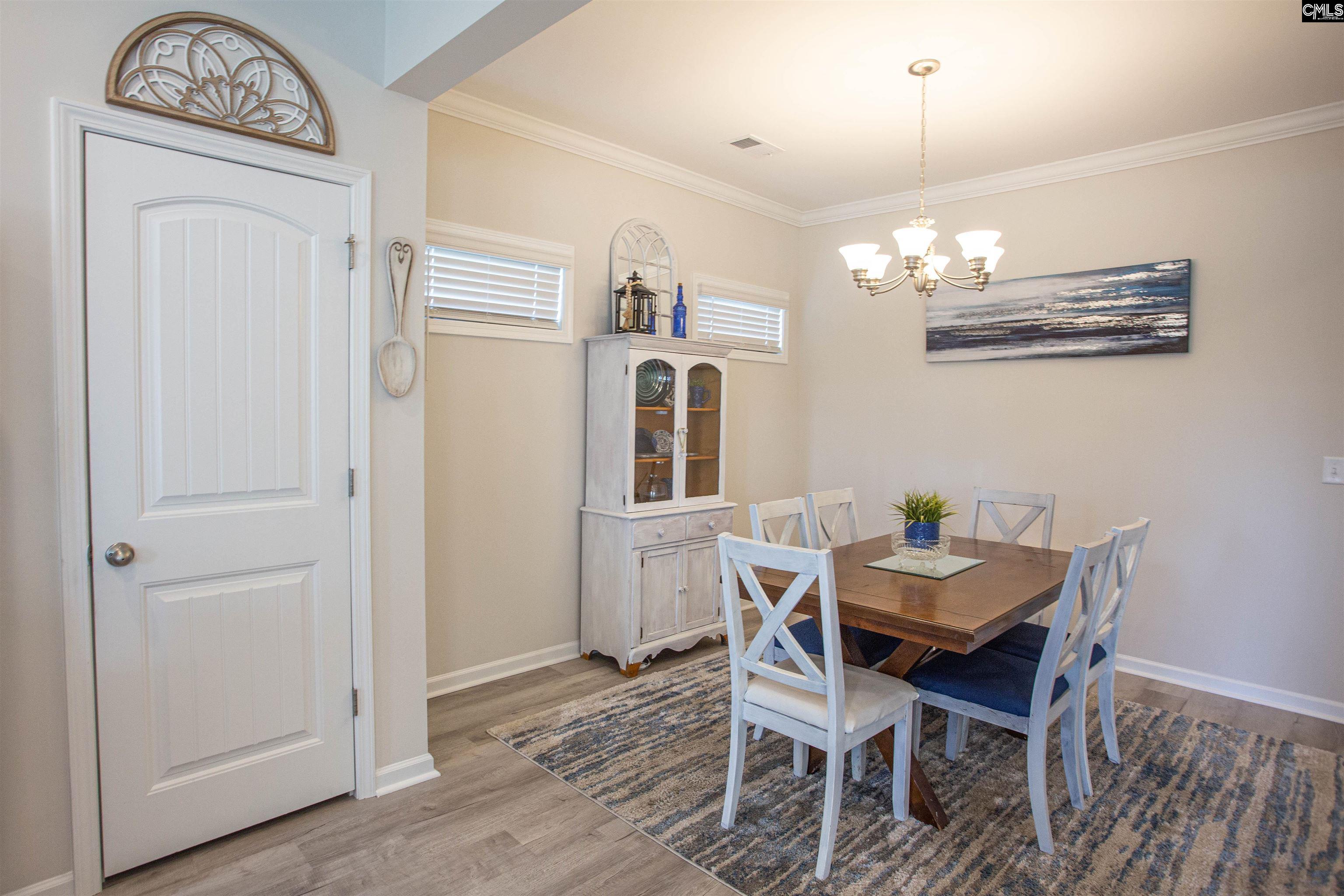 272 Shadowbrook Way Camden, SC 29020 - Photo 5 of 43 a view of a dining room with furniture wooden floor and a chandelier