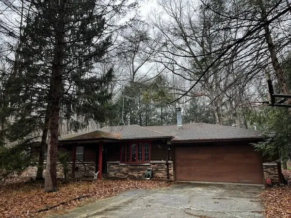 a front view of a building with table and chairs