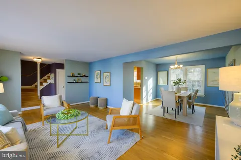 a kitchen with stainless steel appliances kitchen island granite countertop a table and chairs