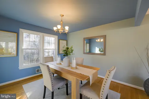 a kitchen with a table chairs refrigerator and a sink