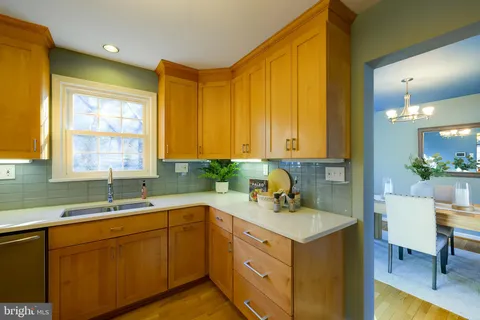 a bedroom with a bed and a lamp on dresser