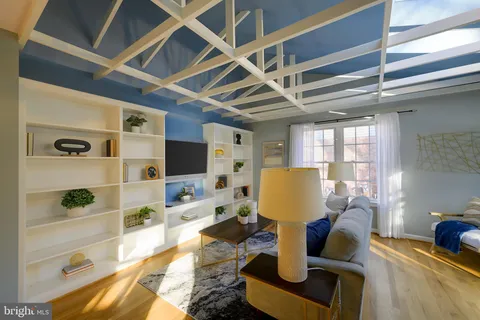 a view of an empty room with window and ceiling fan