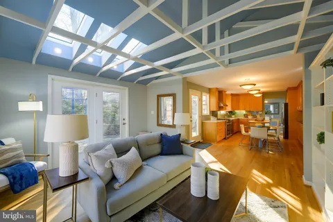 an empty room with windows and ceiling fan