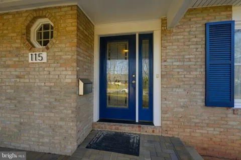 a living room with furniture and a dining table with wooden floor