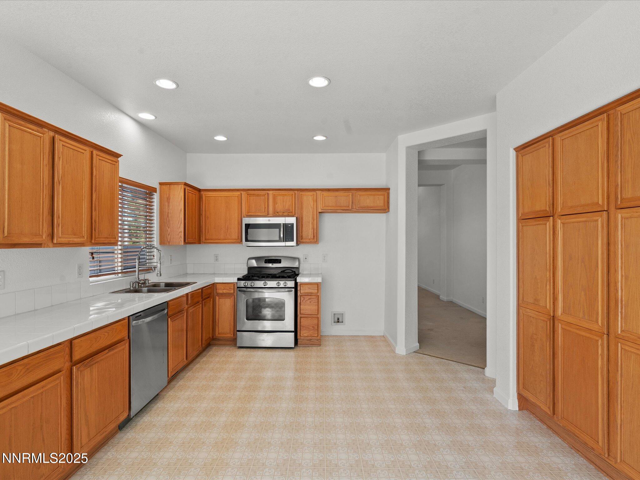 805 Sauvignon Drive Reno, NV 89506 - Photo 13 of 56 a large kitchen with stainless steel appliances granite countertop a refrigerator and a sink