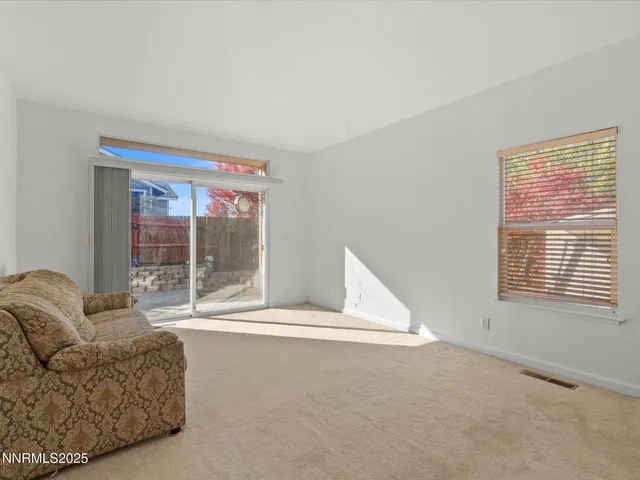 a living room with a couch and a window