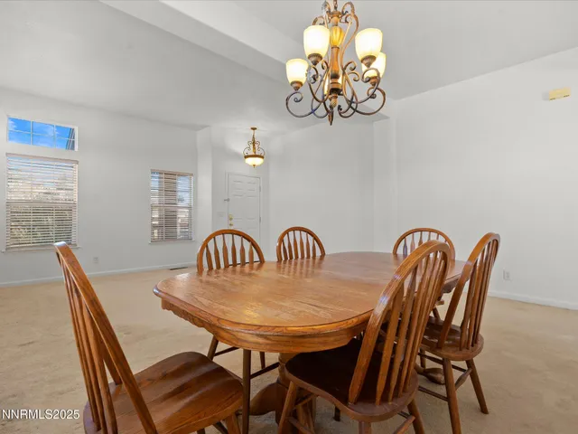 a view of a dining room with furniture and chandelier