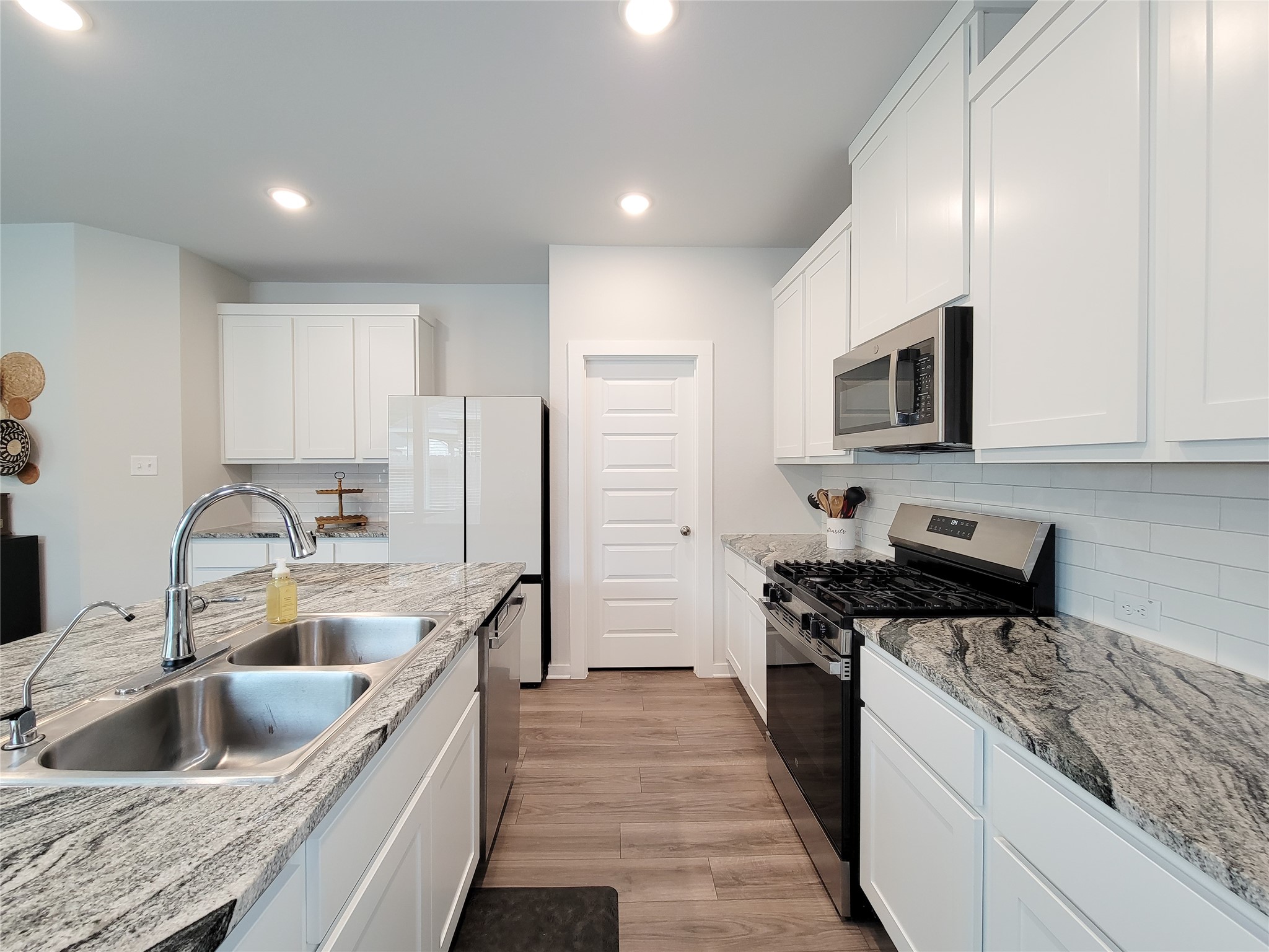 2818 Bluebonnet Ridge Drive Conroe, TX 77304 - Photo 11 of 42 a kitchen with a sink stove top oven and refrigerator