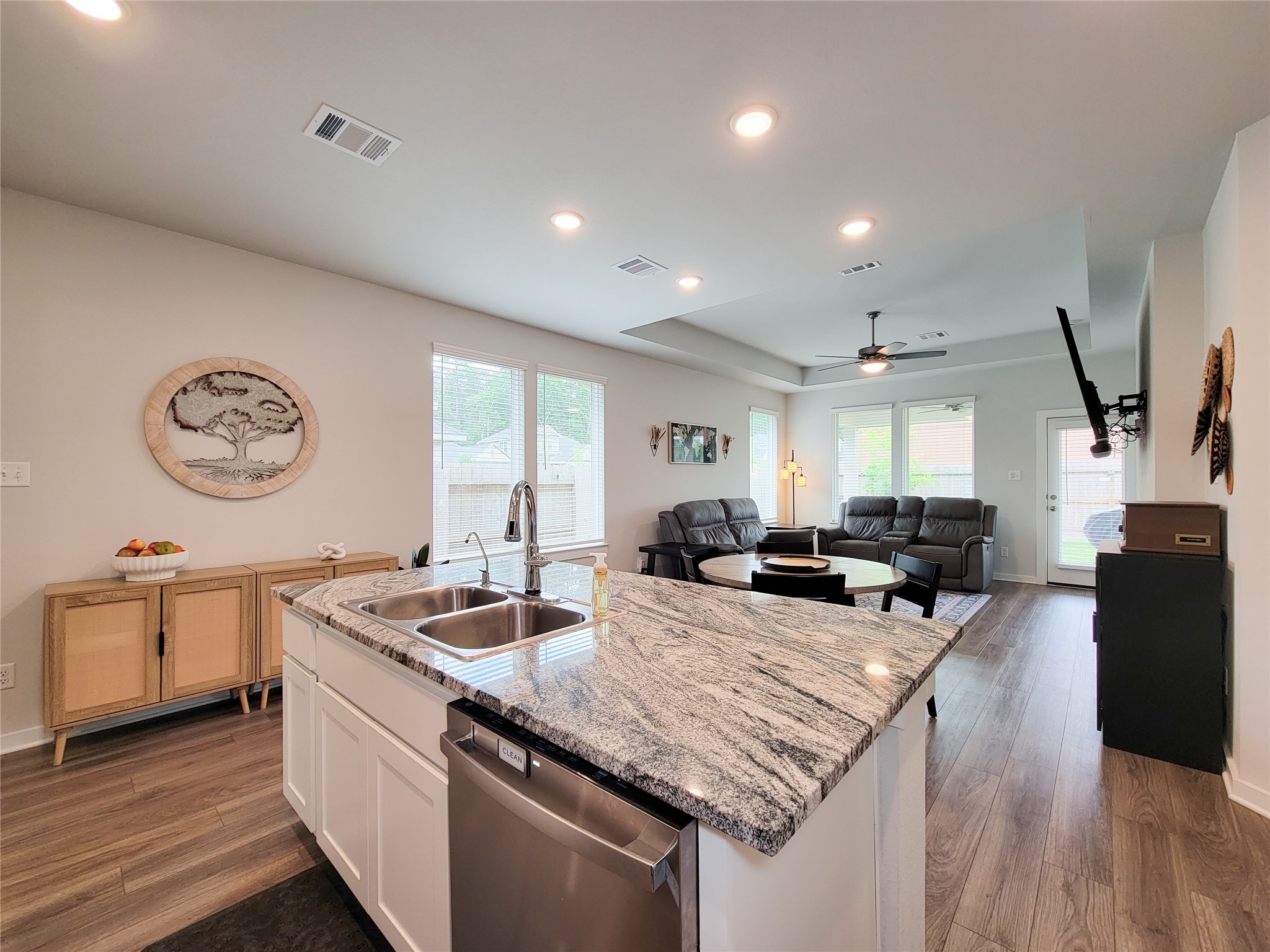 2818 Bluebonnet Ridge Drive Conroe, TX 77304 - Photo 13 of 42 a kitchen with stainless steel appliances granite countertop a sink stove and wooden floor